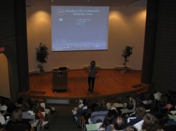 Photo of Christine Speaking in an Auditorium